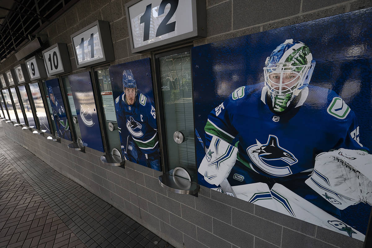 Photos of Vancouver Canucks players are pictured outside the closed box office of Rogers Arena in downtown Vancouver Thursday, April 8, 2021. The Vancouver Canucks say 25 players and coaches have tested positive during a COVID-19 outbreak that involves a variant of the virus. It is now the biggest reported outbreak in the NHL this season. THE CANADIAN PRESS/Jonathan Hayward