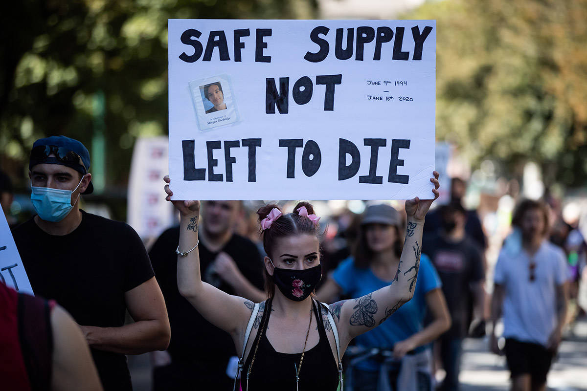 A woman holds up a sign bearing a photograph of Morgan Goodridge during a memorial march to remember victims of overdose deaths in Vancouver on Saturday, August 15, 2020. The B.C. Coroners Service reported a record number of 175 overdose deaths related to illicit drugs in June. Approximately 5,000 people have died due to illicit-drug overdoses since a public health emergency was declared in 2016. THE CANADIAN PRESS/Darryl Dyck