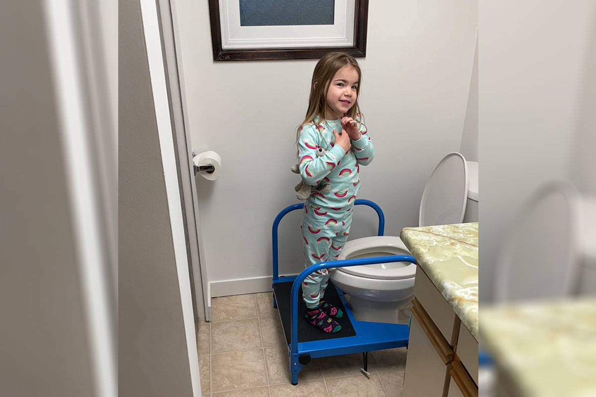 Alice Green, the five-year-old daughter of CanAssist’s managing engineer Paul Green, tries out the pre-production Toilet Step Stool at home. (Photo courtesy Paul Green)