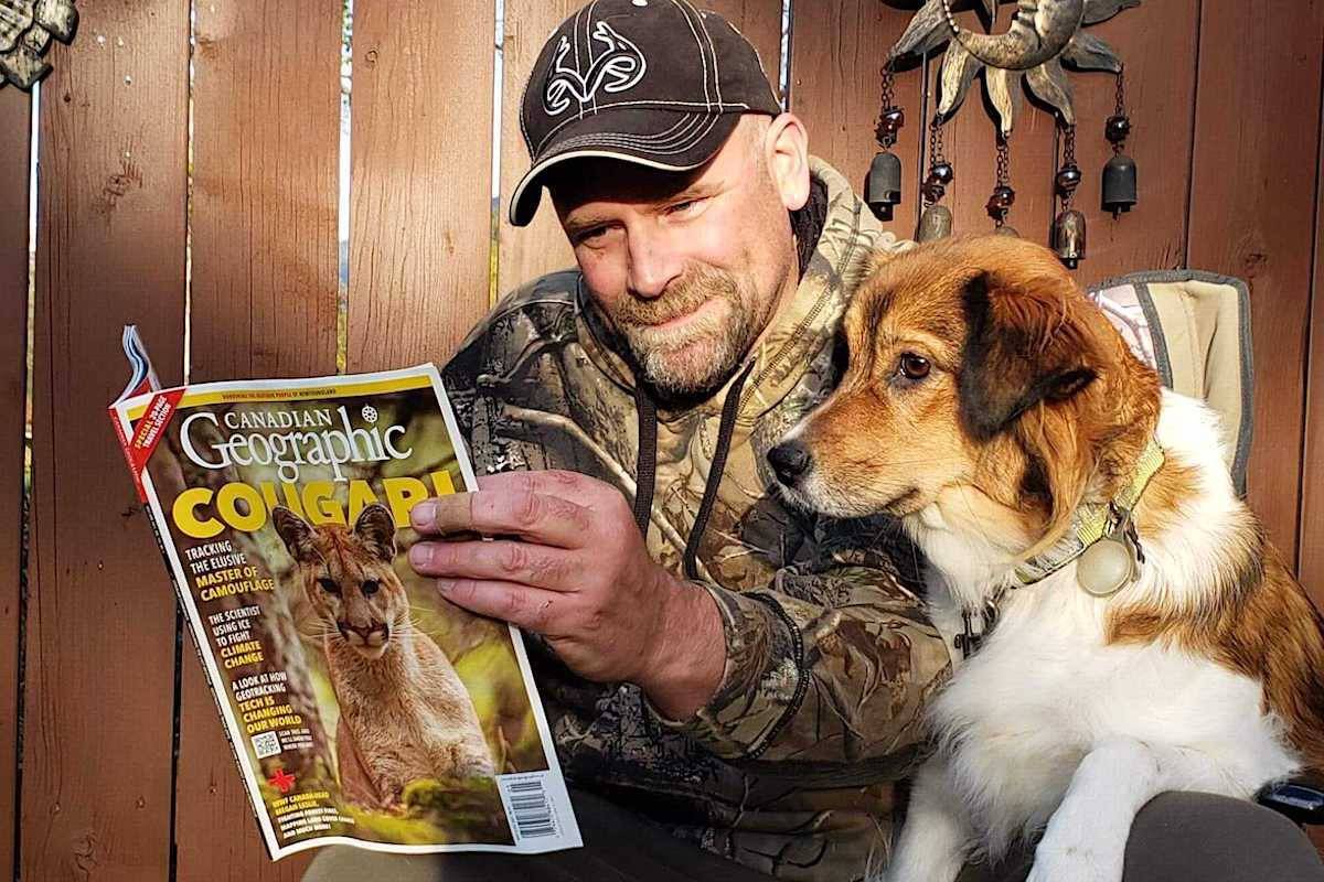 Michael Handley and his field assistant Alice take a look at the new issue of Canadian Geographic. Handley’s picture of a cougar won a reader vote to be on the cover. Photo: Submitted