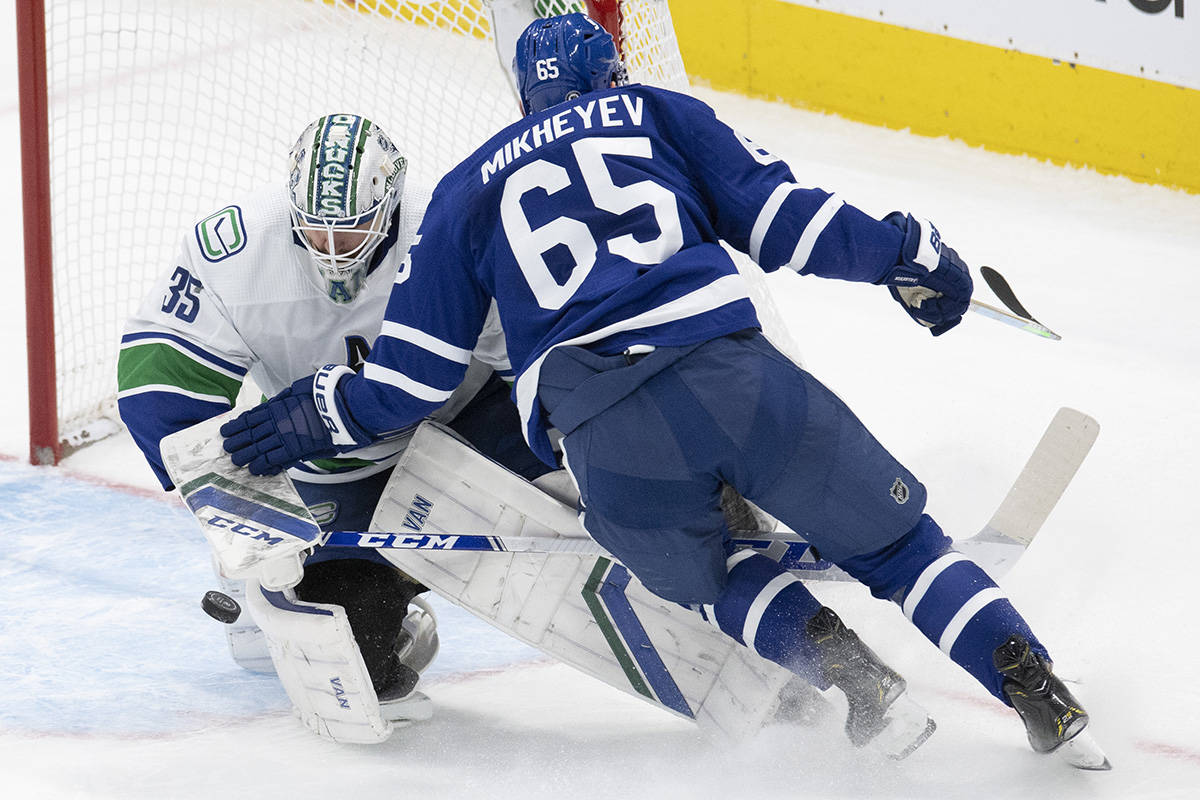Toronto Maple Leafs right wing Ilya Mikheyev (65) collides with Vancouver Canucks goaltender Thatcher Demko (35) on a breakaway during second period NHL action in Toronto on Saturday May 1, 2021. THE CANADIAN PRESS/Frank Gunn