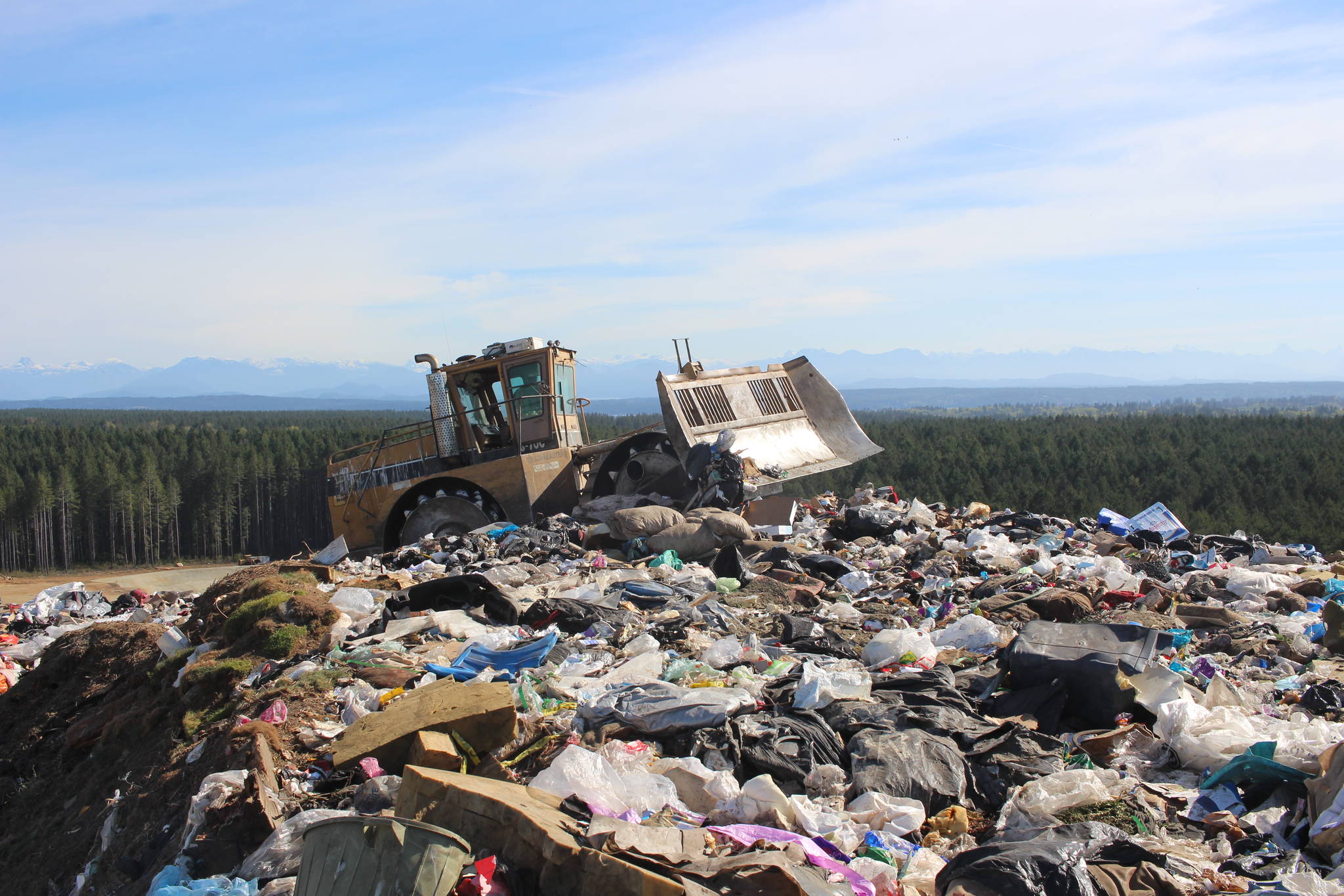 The bulldozer compresses the garbage, squeezing out the air and creating an anaerobic environment perfect for producing methane gas. Photo by Marc Kitteringham, Campbell River Mirror
