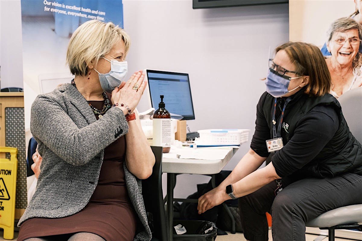 Provincial health officer Dr. Bonnie Henry thanks an Island Health nurse after joining staff for the first round of COVID-19 vaccine, Victoria, Dec. 22, 2020. (B.C. government)