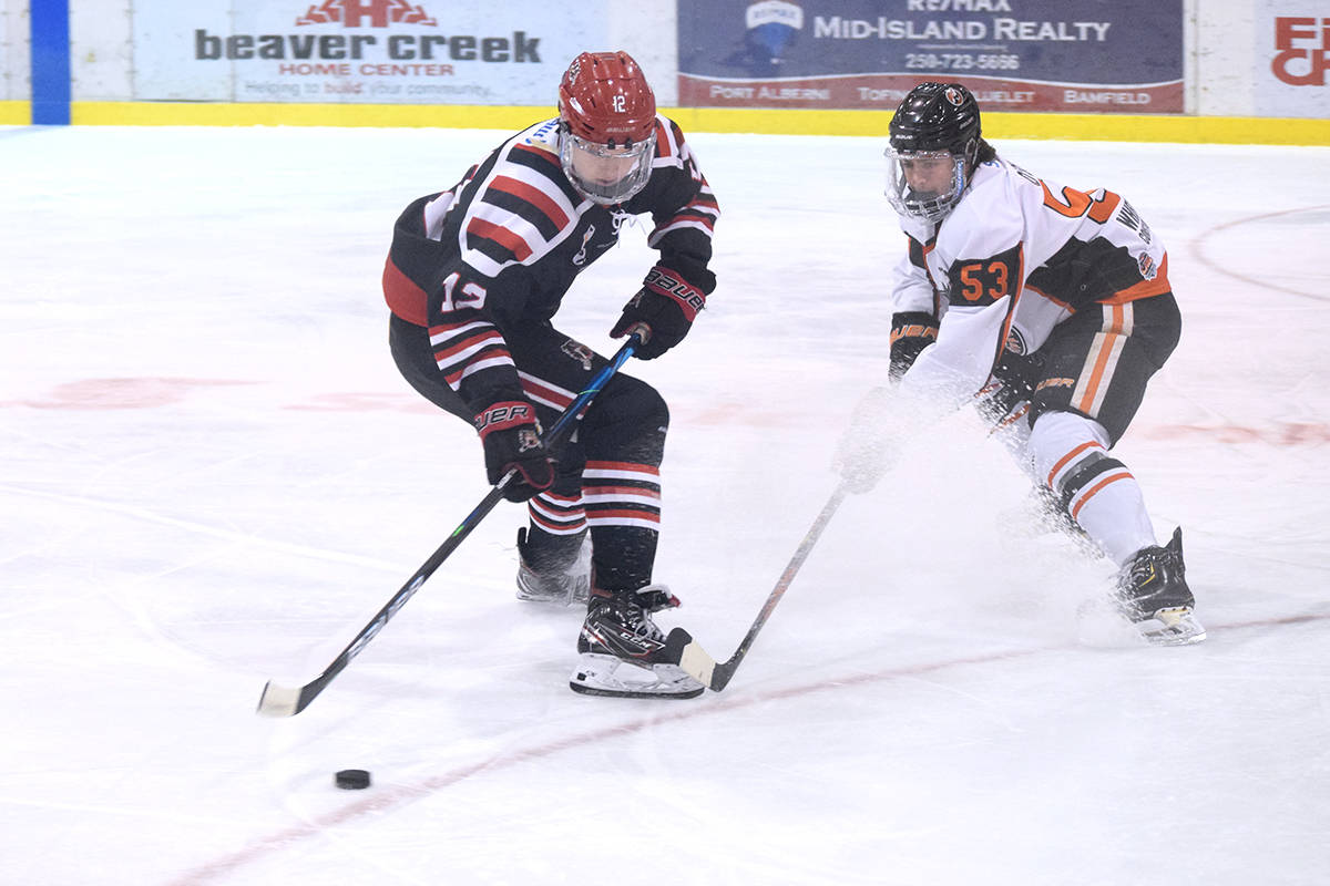 Clippers defenceman Jack O’Brien pokes the puck away from Bulldogs forward Brandon Buhr during a game at the Alberni Valley Multiplex on April 28, 2021. (ELENA RARDON / ALBERNI VALLEY NEWS)