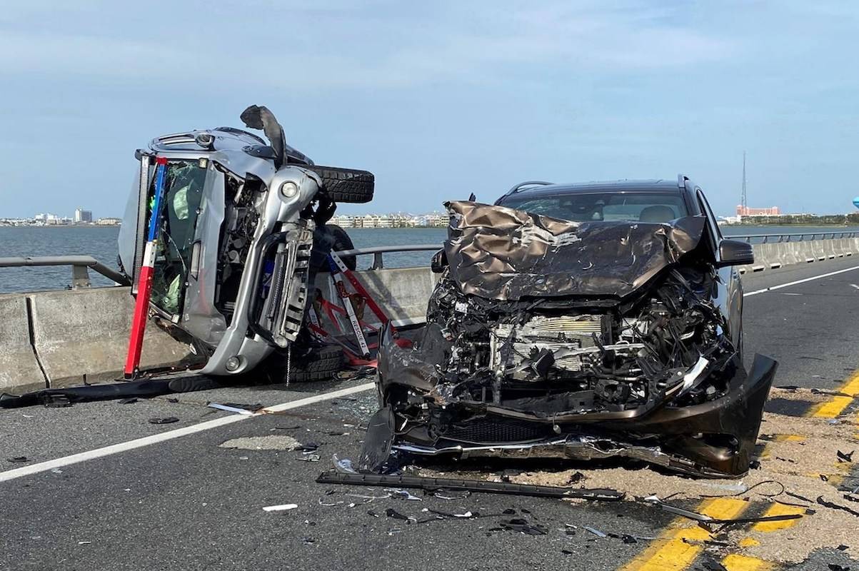 =A bystander jumped over a highway guard rail and into a Maryland bay Sunday to rescue a child who had been thrown from a car and into the water during the crash. (Ocean City Fire Department)
