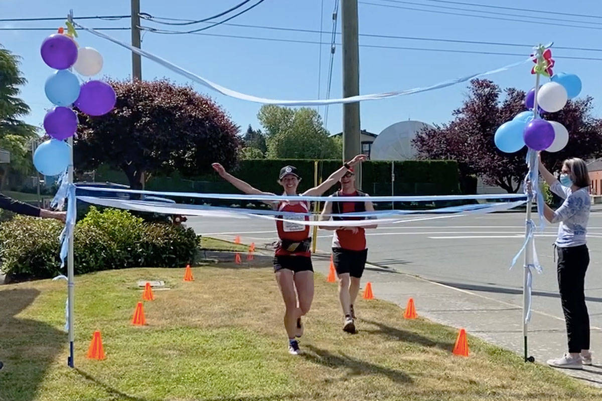 Yana Hempler (left) completed her 21st consecutive marathon on May 21 – part of her 30-in-30 fundraiser for the Victoria Hospital Foundation – with running companion Dr. Jeff Eisen, an emergency room physician at Royal Jubilee Hospital and Victoria General Hospital. (Devon Bidal/News Staff)