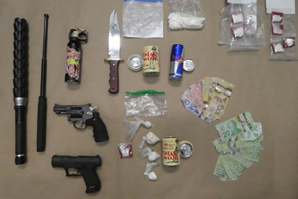 Significant quantities of drugs, cash, stolen goods and weapons from three West Shore RCMP busts last week lay on an exhibit table. (Courtesy West Shore RCMP)