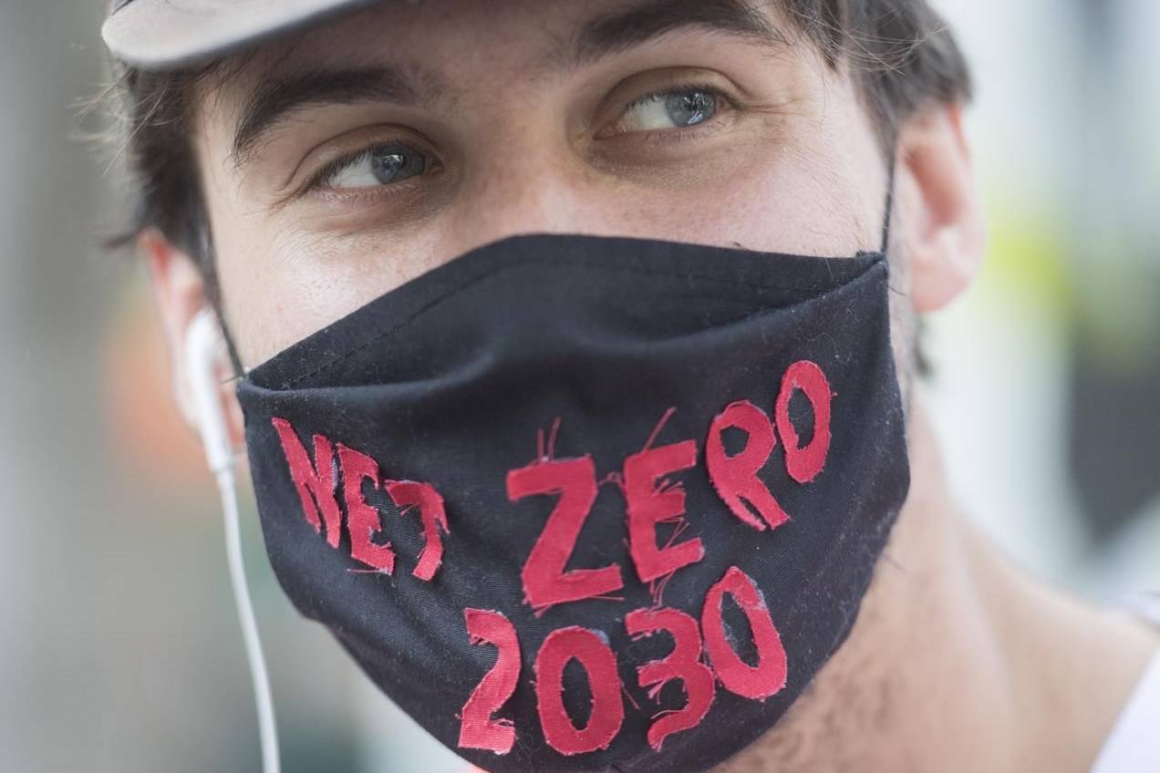 A man attends a climate change protest in Montreal on Saturday, Sept. 26, 2020. A report by the Canadian Institute for Climate Choices says climate change will add more than $100 billion to Canada’s health-care costs by mid-century. THE CANADIAN PRESS/Graham Hughes