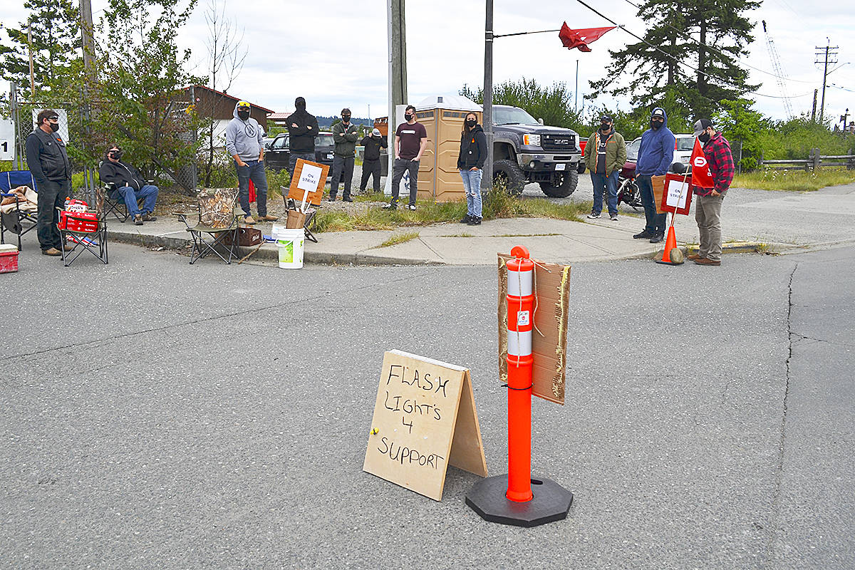 Members of UNIFOR local 3019 walk the picket line at the Myra Falls mine ore loading facility at Tyee Spit in Campbell River June 4. The union walked off the job June 3 after negotiations with mine owner Nyrstar failed to close the gap between the two sides. Photo by AlistaIr Taylor – Campbell River Mirror