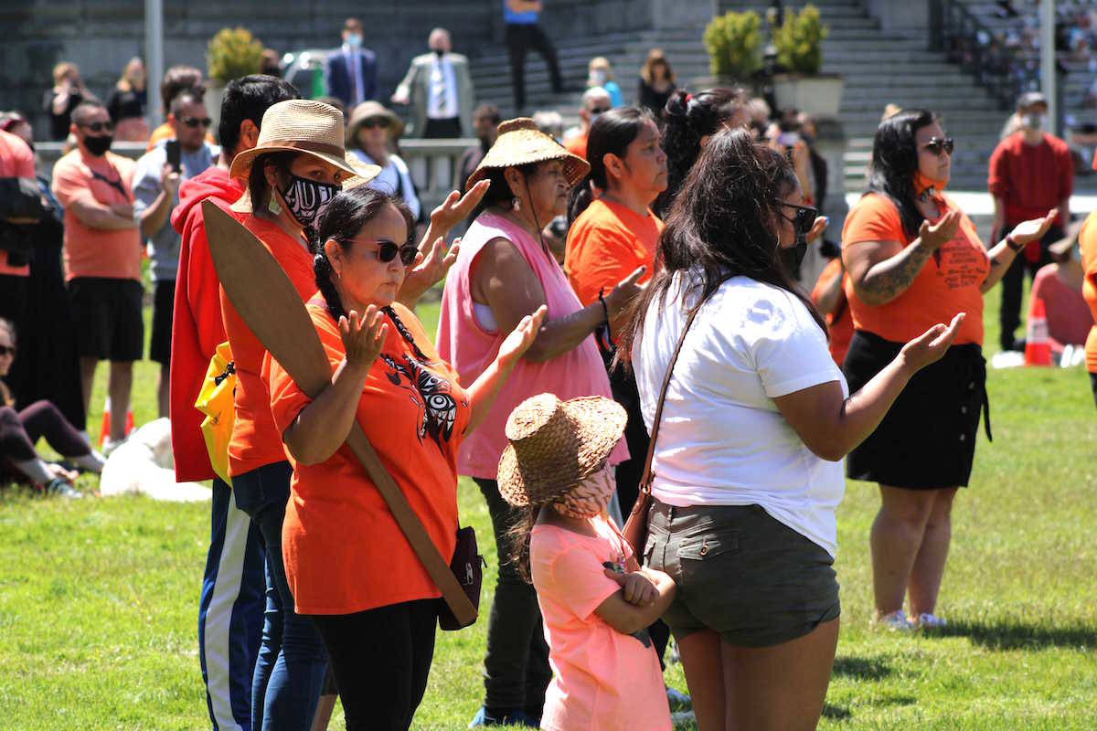 Vancouver Island First Nations and others gather on the lawn of the legislature to honour the 215 children who never came home from a Kamloops residential school. The timing of the discovery will affect Victoria’s marking of July 1 as Canada Day this year. (Jake Romphf/News Staff)