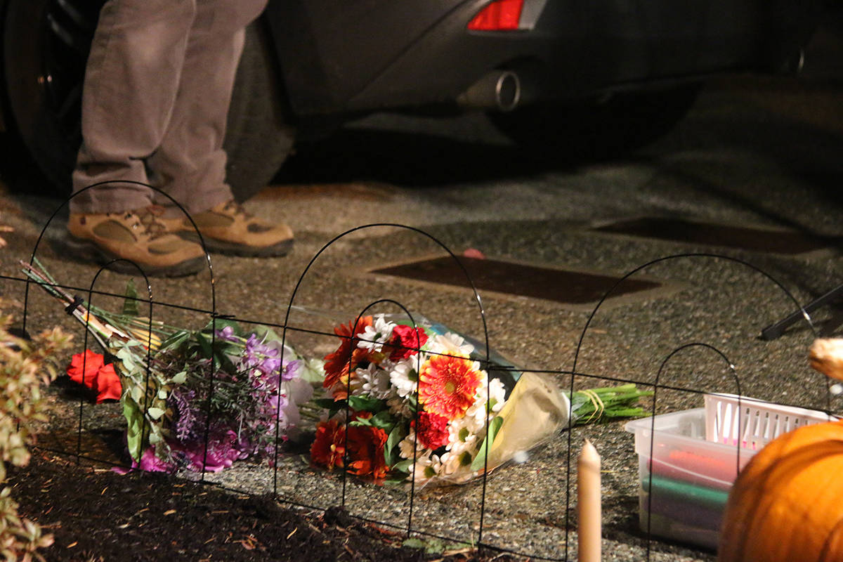 Flowers and candles were laid on the driveway of the Weber home, where Kerri Weber was found dead in November 2020. (Black Press Media file photo)
