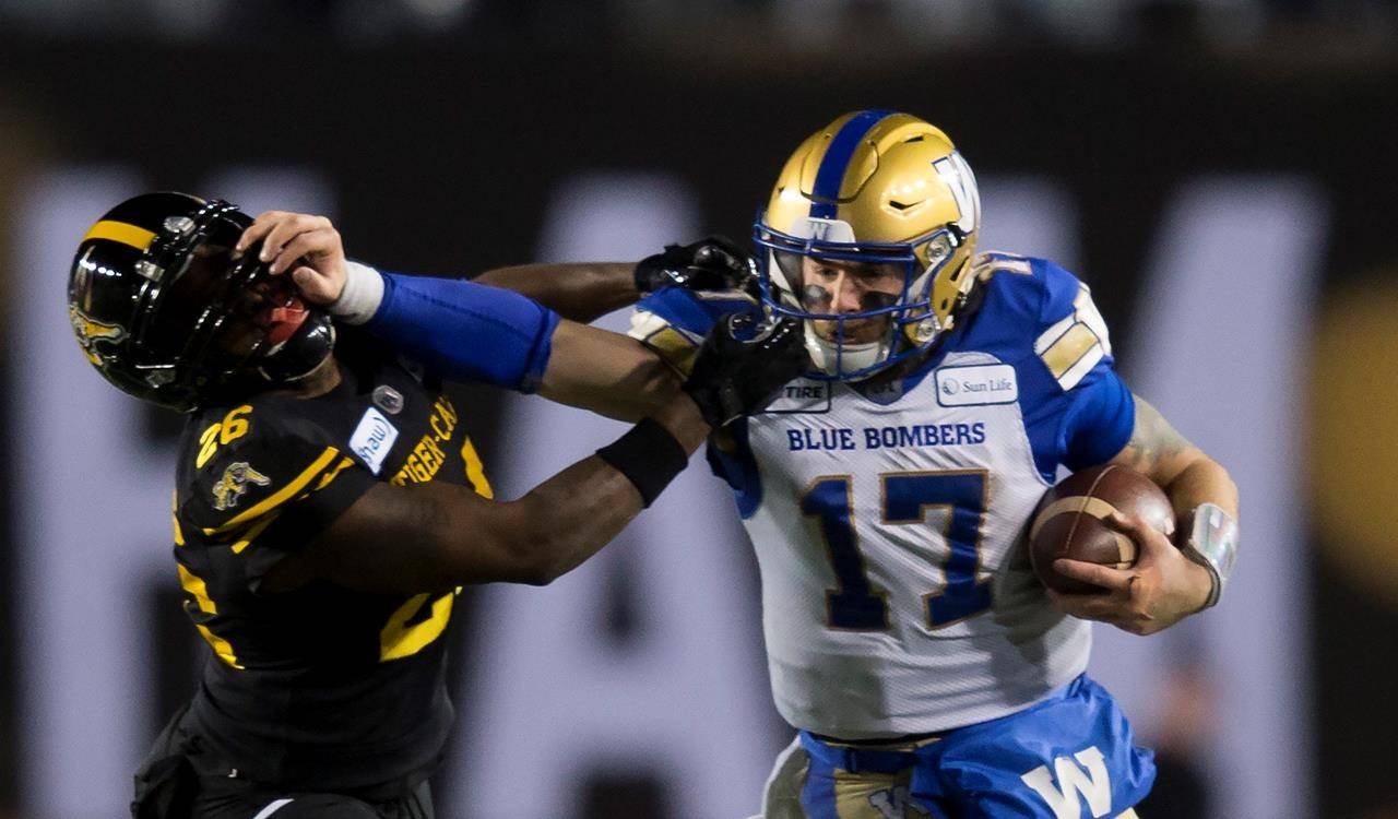 Winnipeg Blue Bombers quarterback Chris Streveler pushes away Hamilton Tiger-Cats’ Cariel Brooks during the second half of the 107th Grey Cup in Calgary, Alta., Sunday, November 24, 2019. THE CANADIAN PRESS/Todd Korol