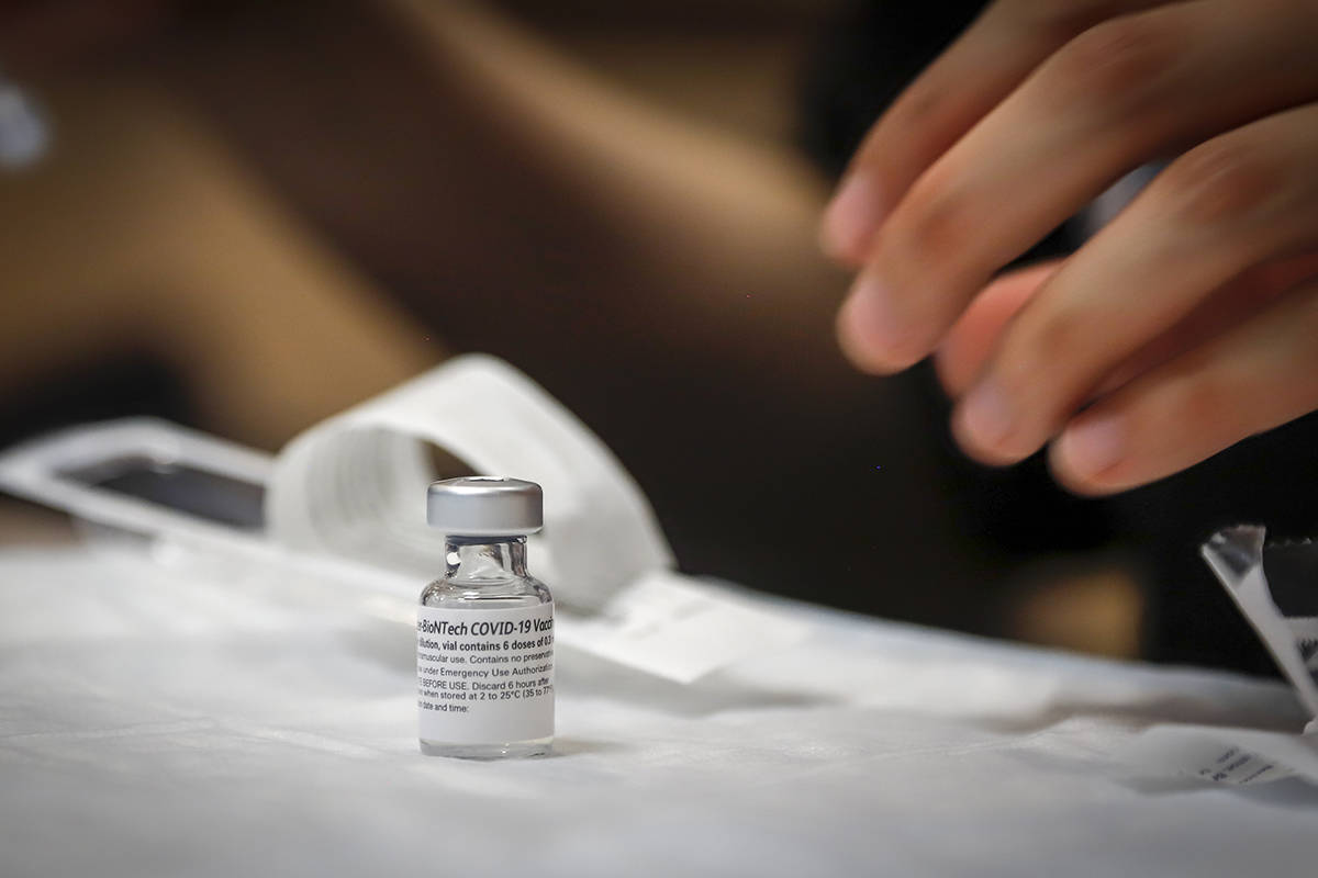 FILE – Nurse Iciar Bercian prepares a shot at a vaccine clinic for the homeless in Calgary, Alta., Wednesday, June 2, 2021. THE CANADIAN PRESS/Jeff McIntosh