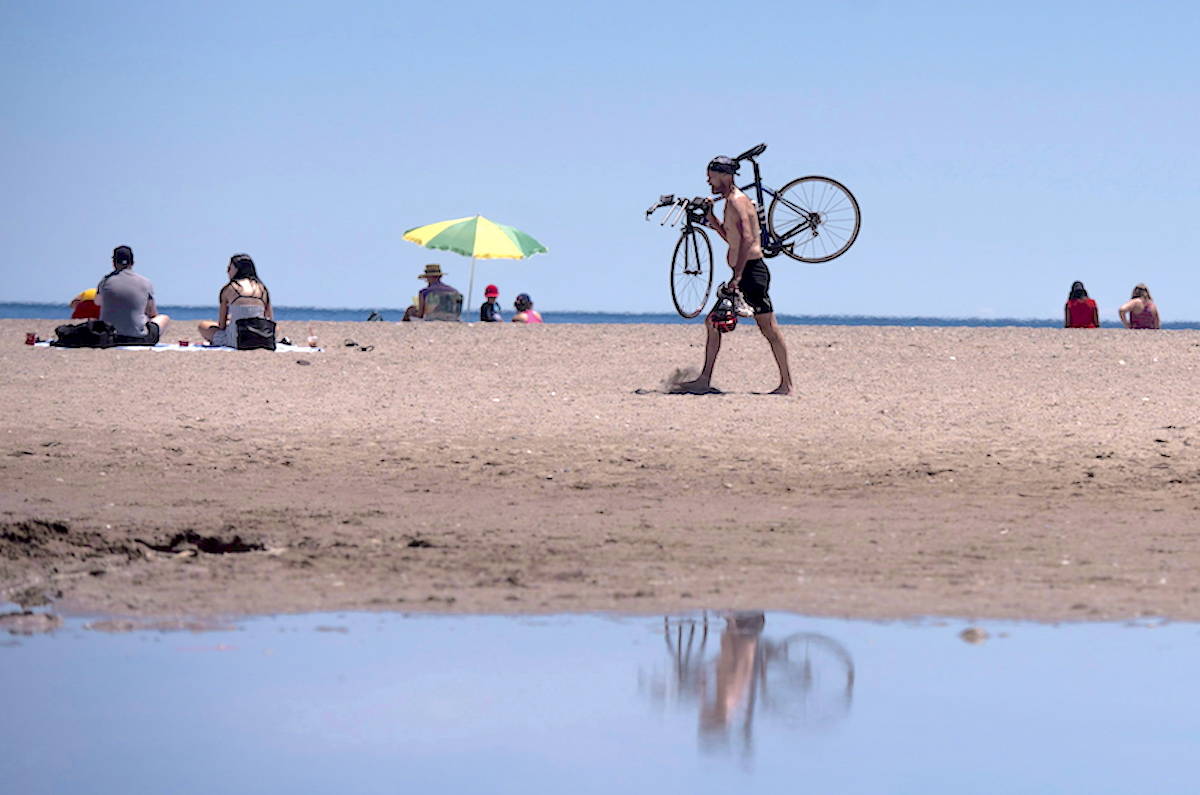 People enjoy the sun at Woodbine Beach on June 19, 2018. THE CANADIAN PRESS/ Tijana Martin