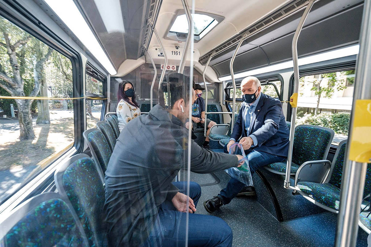 Premier John Horgan took his old bus route around Greater Victoria, handing out masks to BC Transit passengers in July 2020 as masks became required on transit. (John Horgan/Facebook)