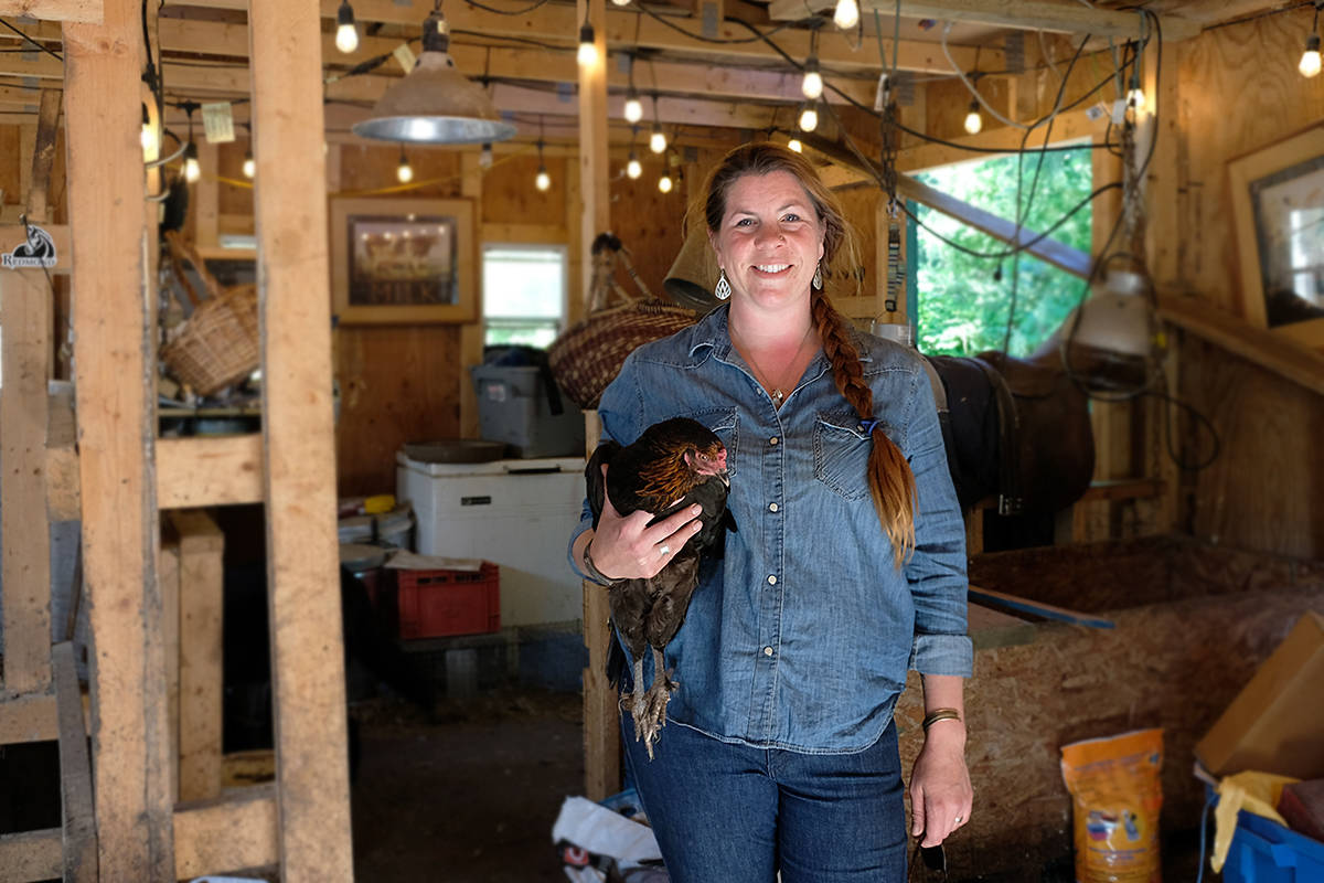 Kristy Sivorot in the barn where chickens roam and stray cats live a happy barn life. (Zoe Ducklow - Sooke News Mirror)