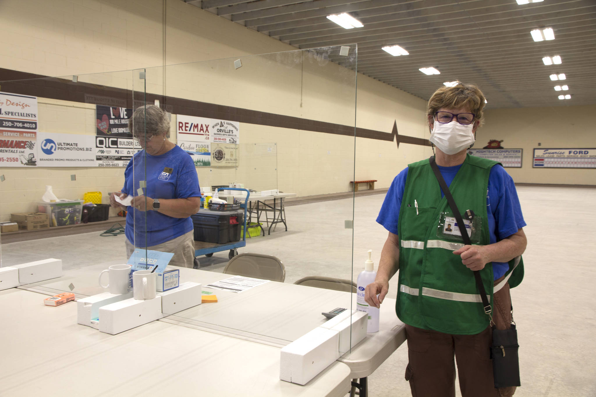 Liz Jones (right), of Emergency Support Services, at one of the reception tables at the South Cariboo Rec Centre. (Kelly Sinoski photo - 100 Mile Free Press).