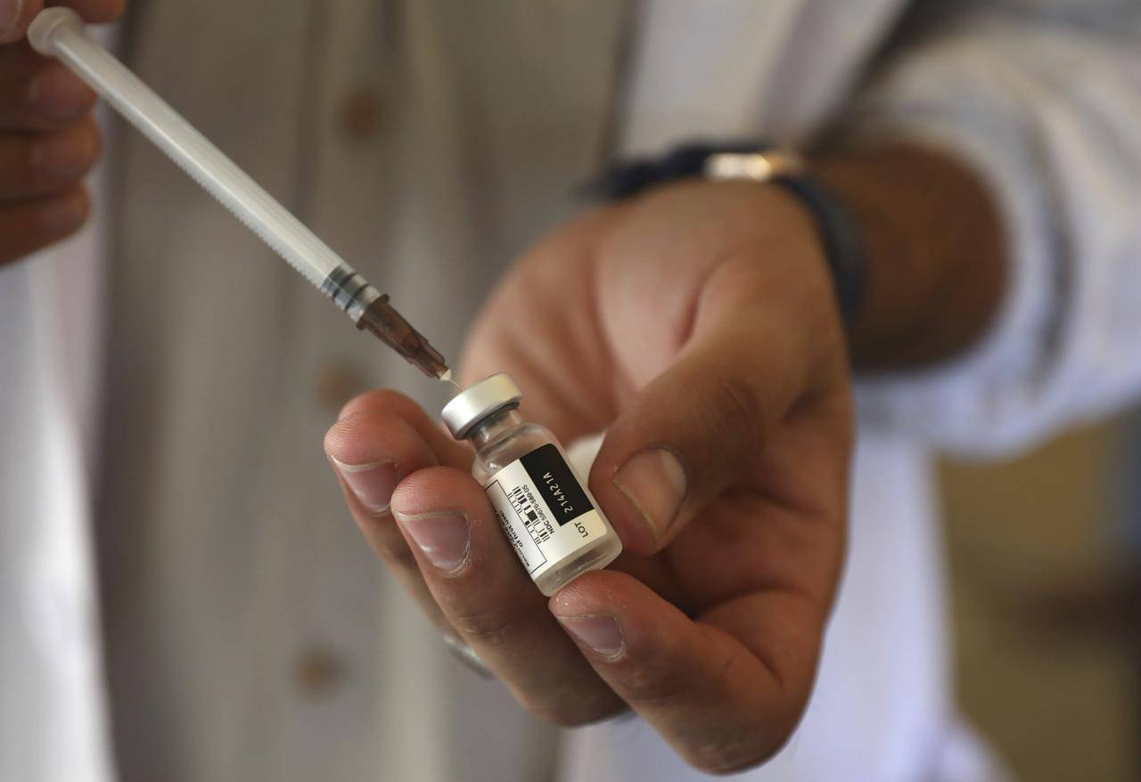 FILE - In this Sunday, July 11, 2021 file photo, a doctor fills a syringe with the Johnson & Johnson COVID-19 vaccine at a vaccination center in Kabul, Afghanistan. Top officials at the World Health Organization said Monday, July 12 there is not enough evidence to show that third doses of coronavirus vaccines are needed and appealed for the scarce shots to be shared with poor countries who have yet to immunize their populations instead of being used by rich countries as boosters. (AP Photo/Rahmat Gul, file)