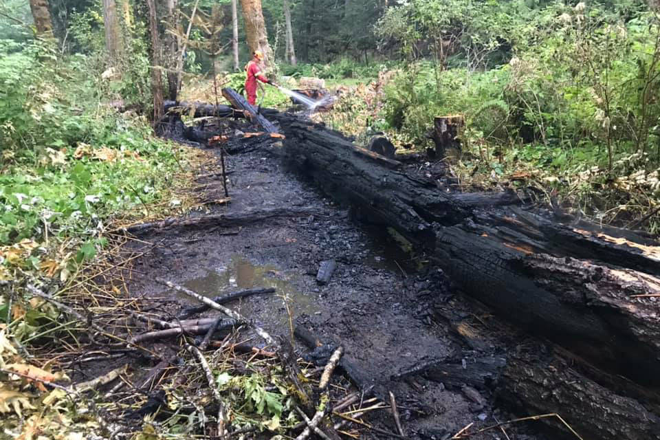 A firefighter with Port Alberni Fire Department mops up a fire in Dry Creek Park early Tuesday, July 13, 2021. It was the second fire crews attended in a few hours in Dry Creek. (PHOTO COURTESY PAFD)