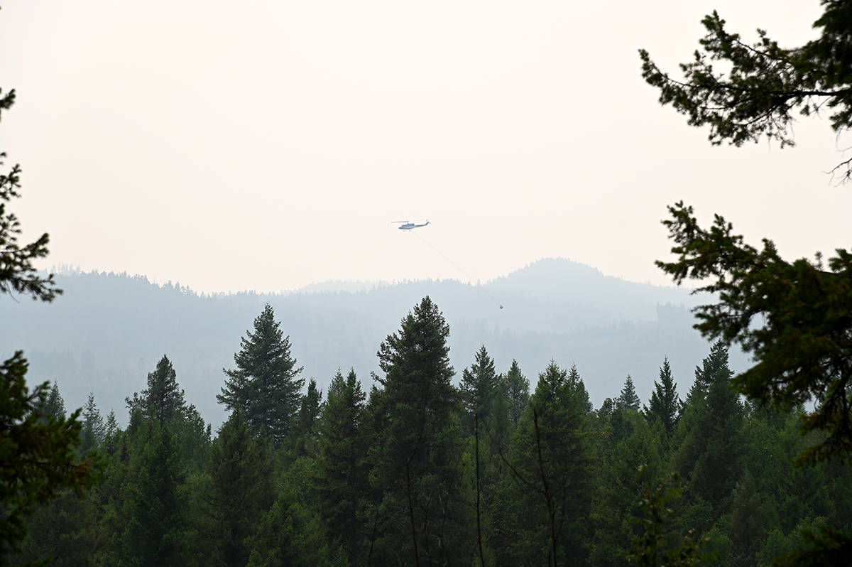 A helicopter was seen flying over the Clearwater River with a bucket July 14, the skies very smoky. (Stephanie Hagenaars / Clearwater Times)