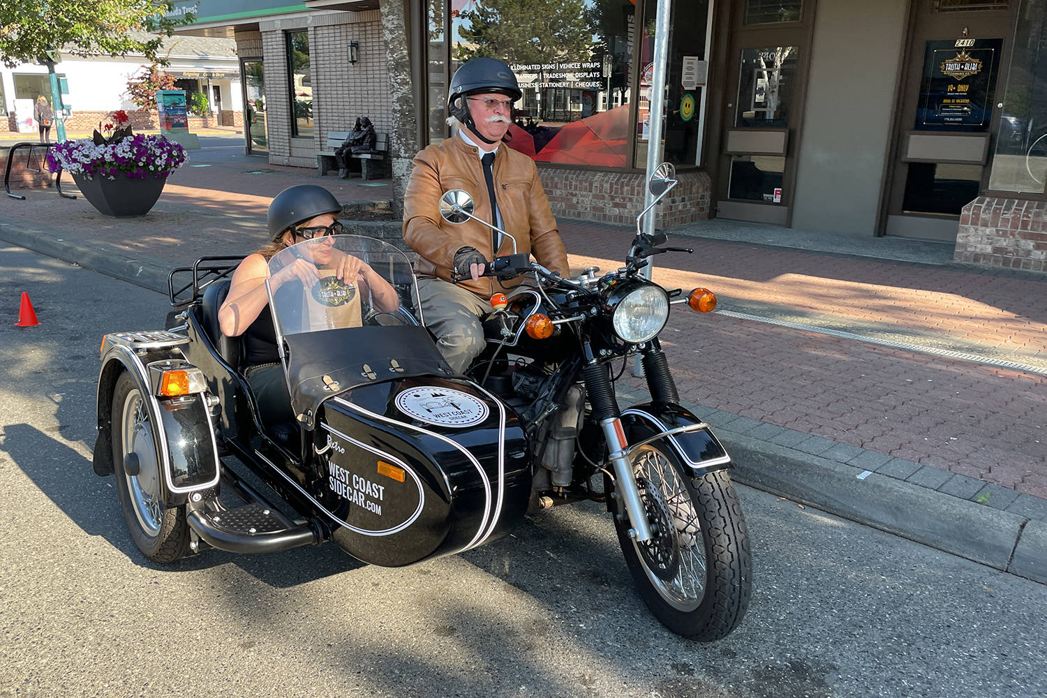 Cindy Pendergast, left, of Sidney’s Truth and Alibi cannabis shop heads out to make what was believed to be the first delivery of cannabis in British Columbia, following that service’s legalization July 15. (Photo courtesy Truth and Alibi)