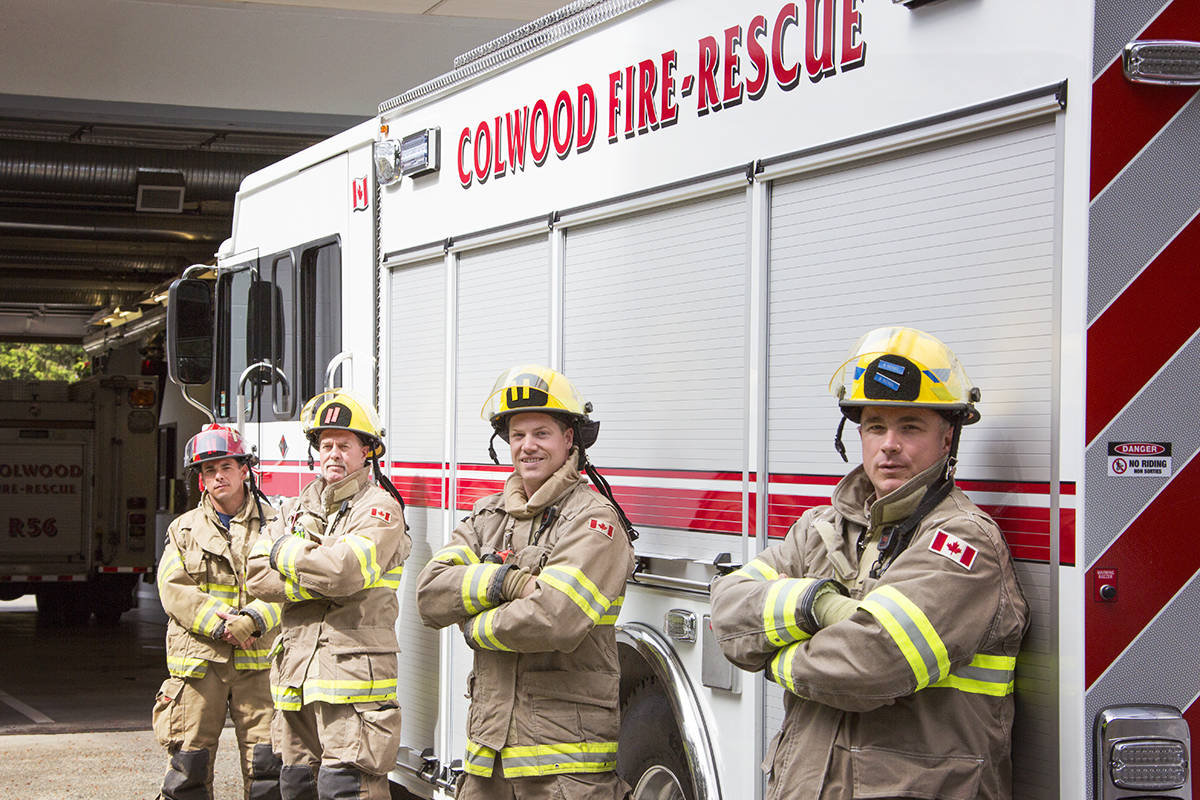 Firefighters Bryan McNeil (from right), Michael Poole, Josh Pettigrew and Captain Bryan Erwin get acquainted with Colwood Fire Rescue’s new engine. (Katherine Engqvist/News Staff)