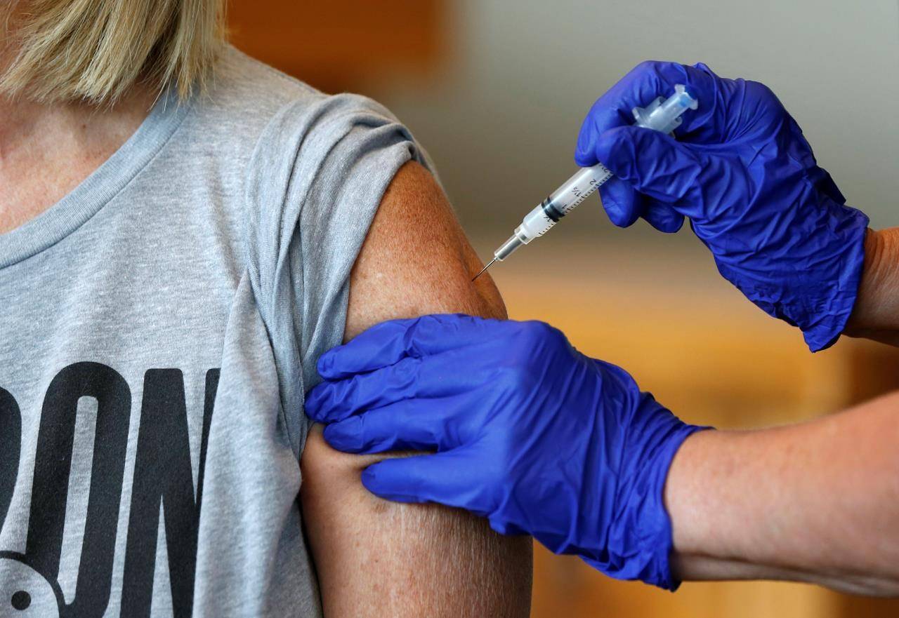 FILE - In this Monday, July 12, 2021, file photo, Karen Martin receives a COVID-19 vaccine at a vaccination clinic hosted by James River Church West Campus in conjunction with Jordan Valley Community Health Center in Springfield, Mo. (Nathan Papes/The Springfield News-Leader via AP, File)
