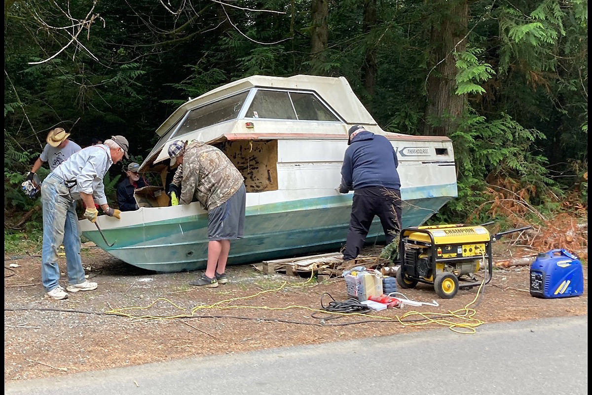 Sooke ATV Club members collected a dumpster load of garabhe, including an abandoned boat, while doing a cleanup along Anderson Road near Muir Creek on July 17. (Contributed - Sooke ATV Club)