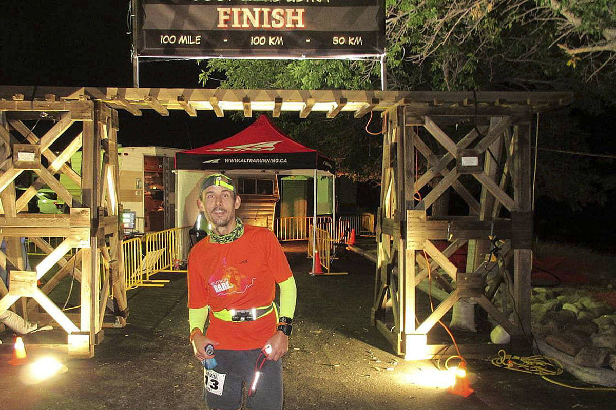 Jerry Hughes at the finish line of one of his previous running fundraisers for children in need. (Photo courtesy of Help Fill a Dream)
