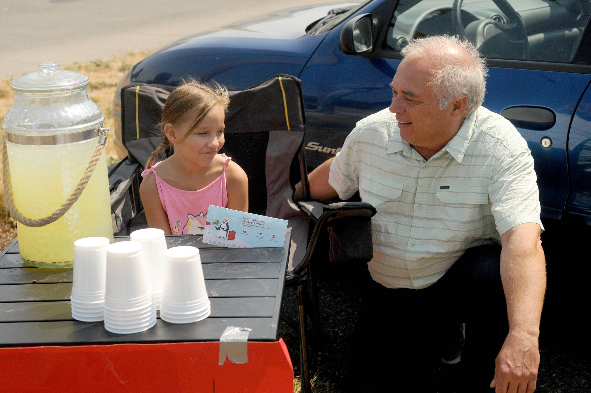 Nine-year-old Chilliwackian Emily Loewen shares a moment with Lytton mayor Jan Polderman on Tuesday. Loewen presented Polderman $3,440 on Tuesday, Aug. 3, most of it raised through lemonade sales. (Eric J. Welsh/ Chilliwack Progress)