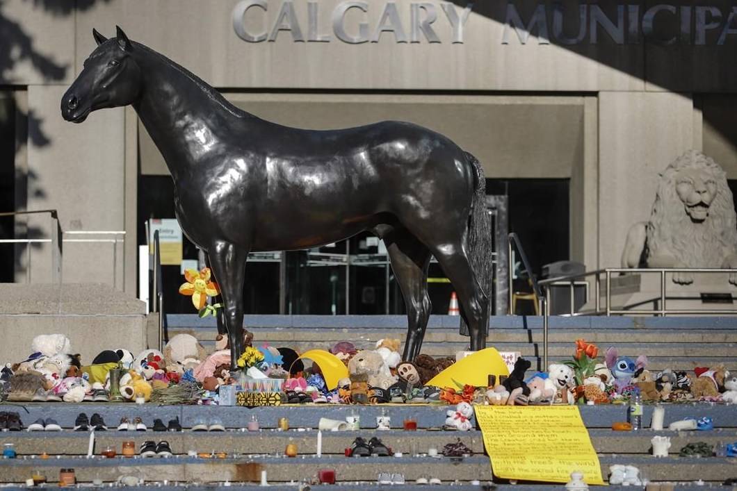 A growing memorial, in honour of the 215 residential school children whose remains have been discovered buried near the former residential school in Kamloops, B.C., sits outside Calgary City Hall in Calgary, Alta., Wednesday, June 2, 2021. Calgary police say they are investigating an arson at the memorial. THE CANADIAN PRESS/Jeff McIntosh