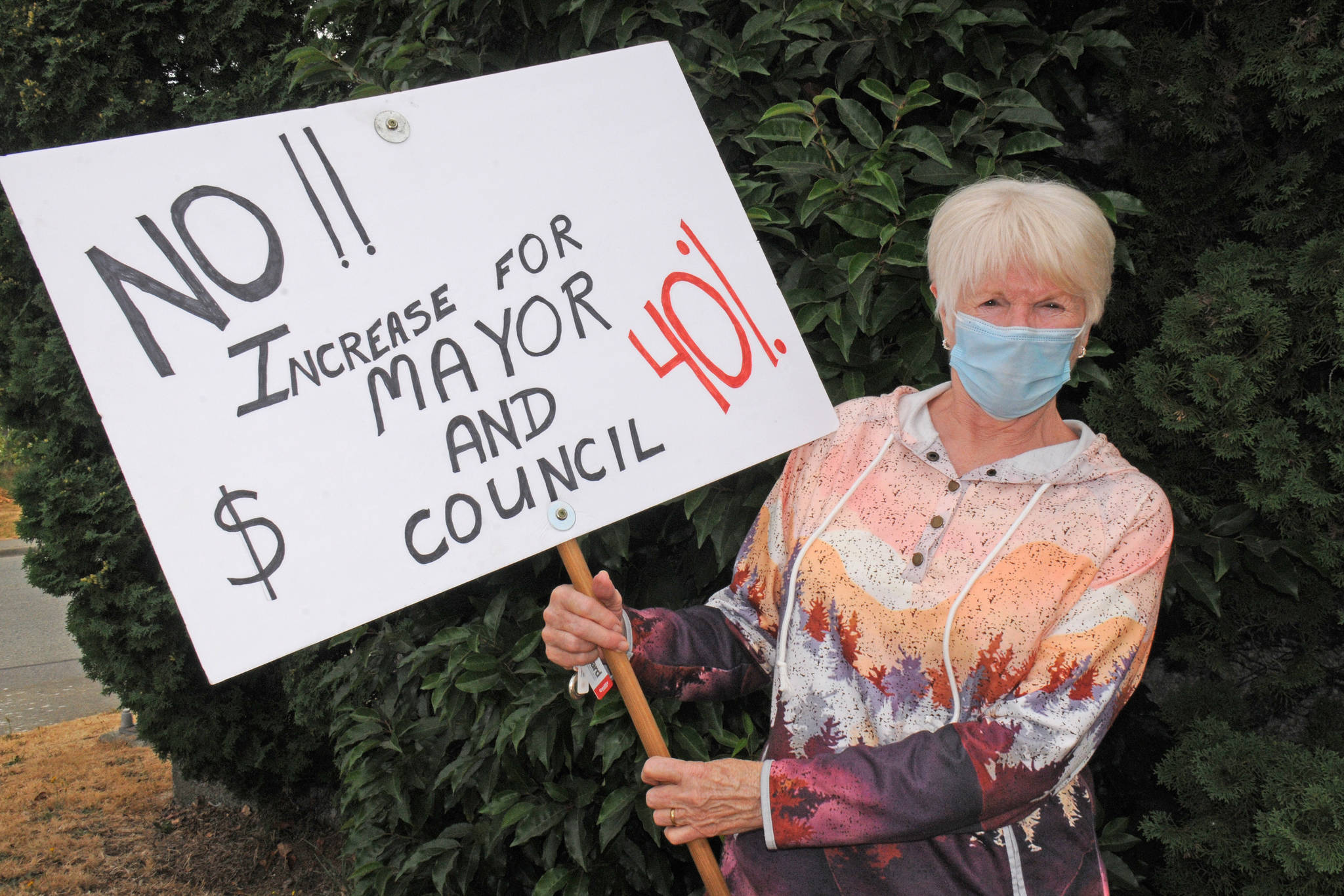 Diane Proctor of Port Alberni is so upset about city council’s recent decision to increase wages that she has been picketing with a sign out front of city hall and other locations. (SUSAN QUINN/ Alberni Valley News)
