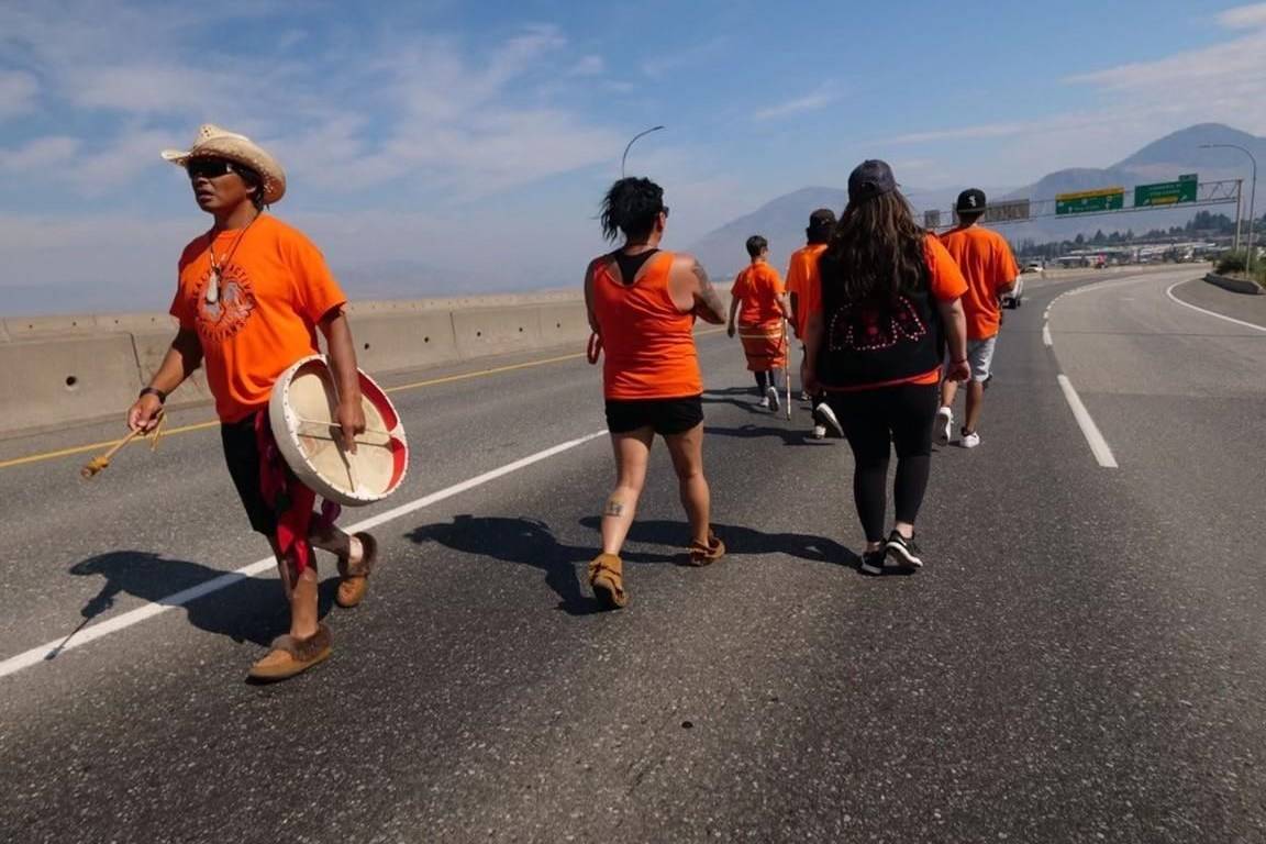 Jamie Henyu, left, participates in the Warriors Walk for Healing Nations in Kamloops, B.C. on Monday, August 9, 2021. A six-week journey starting from Yukon and covering more than 2,000 kilometres has finished today in Kamloops, British Columbia — which the man behind the Warriors Walk for Healing Nations calls “ground zero for where the truth broke out.” THE CANADIAN PRESS/HO - Tahltan Central Government