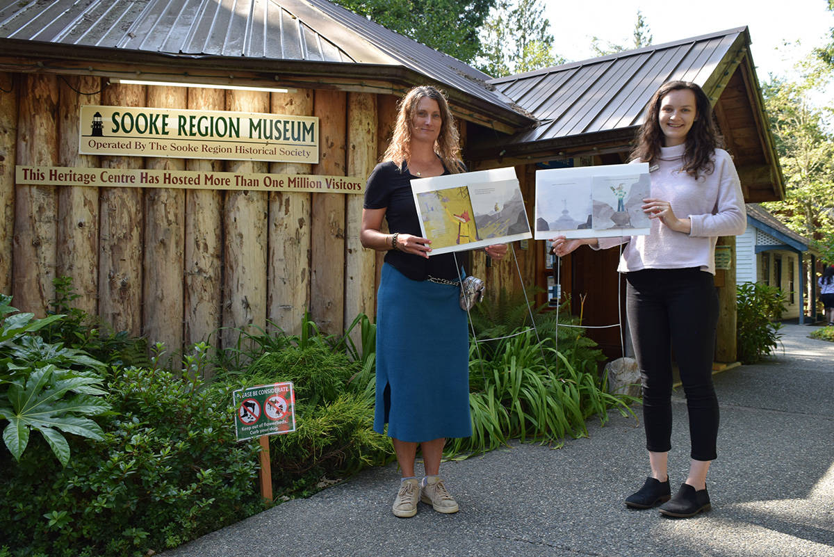 Museum program director Wendy Johnson, left, and Vancouver Regional Library children’s librarian Nathalie Jones with two panels of the museum’s latest story walk installment, The Golden Glow. (Kiernan Green - Sooke News Mirror)