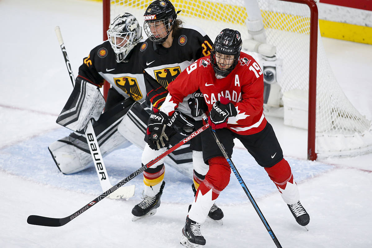 Canada’s Brianne Jenner, right, and Germany’s Tabea Botthof, centre, battle for position as goalie Sandra Abstreiter looks on during third period quarterfinal IIHF Women’s World Championship hockey action in Calgary, Saturday, Aug. 28, 2021.THE CANADIAN PRESS/Jeff McIntosh