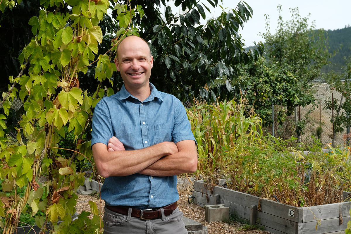 Principal Mike Bobbitt is thrilled to be back in the thick of things at Edward Milne Community School, such as in the garden where a wily gardener can spot hops, persimmon, corn, potatoes and quince. And that’s just in this photo. (Zoe Ducklow - Sooke News Mirror)