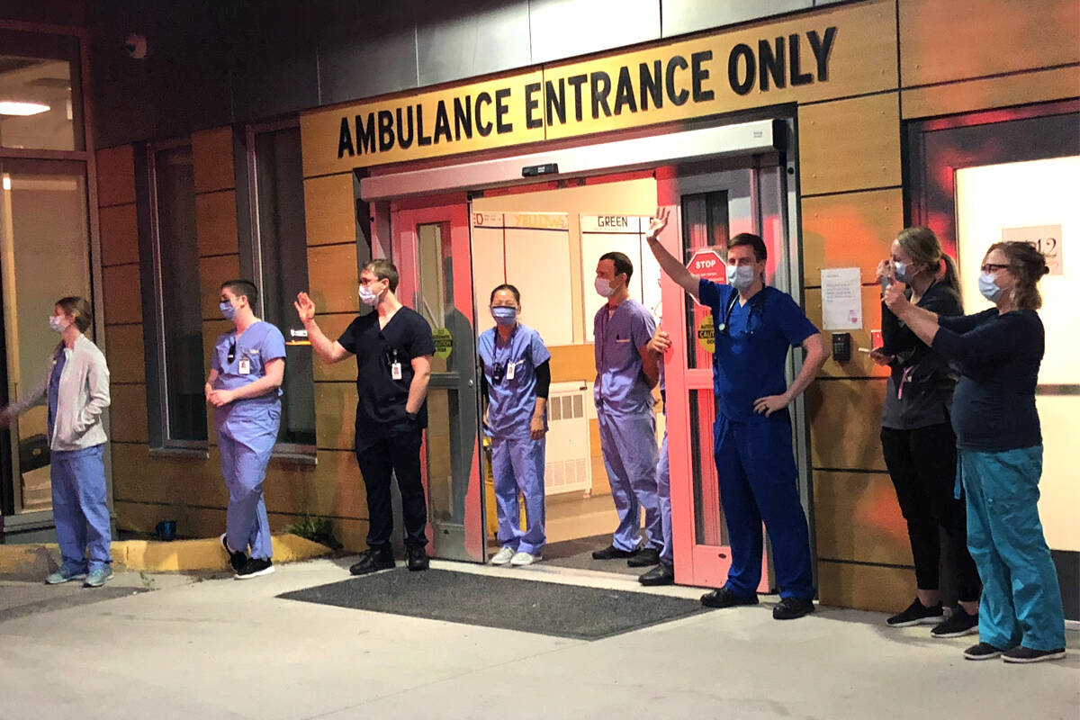 Doctors and nurses gathered outside the emergency room at Nelson’s Kootenay Lake Hospital on Friday evening as local police and firefighters paraded by to show support. Photo: Tyler Harper