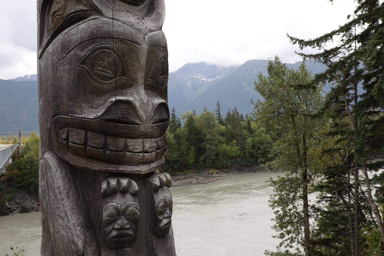 One of four totem poles on the corners of a bridge over the Nass River to Gitwinksihlkw (Canyon City) in northwestern British Columbia is seen on Saturday, Sept. 1, 2018. The Indigenous Tourism Association of Canada is making a bleak prediction about its members’ ability to rapidly recover from the COVID-19 pandemic. THE CANADIAN PRESS/Colin Perkel