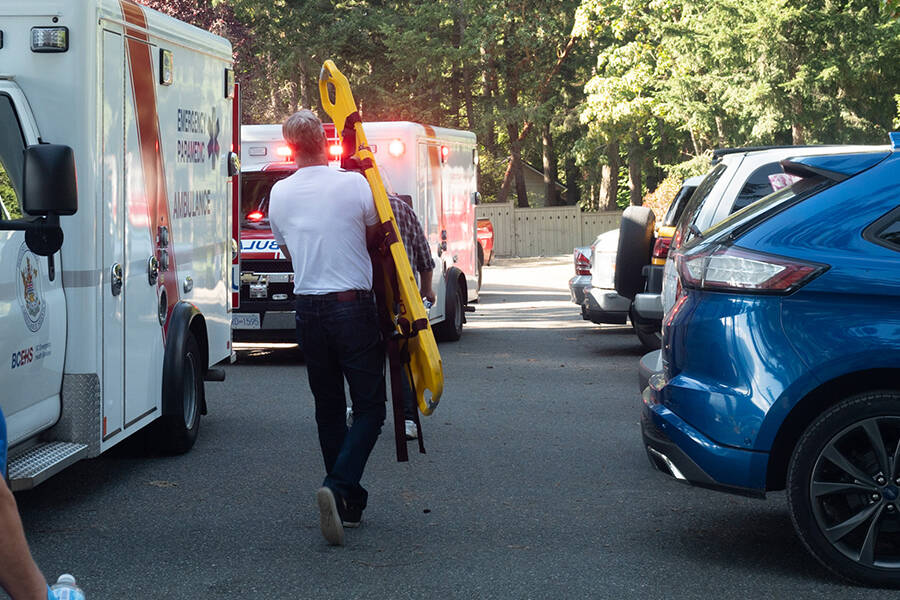 Raven Point Marina owner Daniel Maloney assists emergency crews after a man stepped on a flair at the docks and suffered serious burns on Sept. 23. (Photo by Tyler Hay)