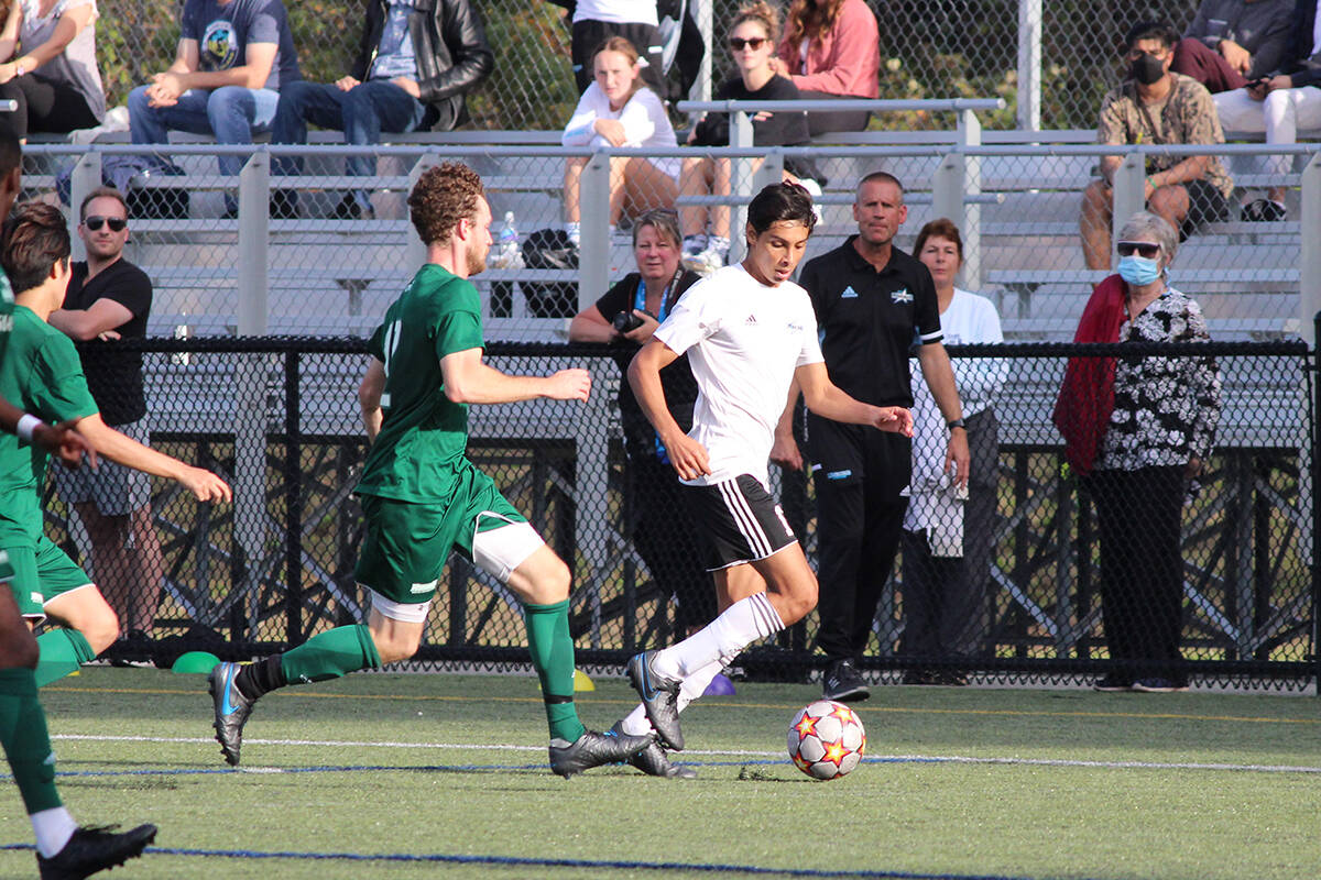 VIU Mariners player Hector Valdez keeps the ball away from a Douglas Royals opponent during a PacWest match Saturday, Sept. 25, at Merle Logan Field. (Karl Yu/News Bulletin)