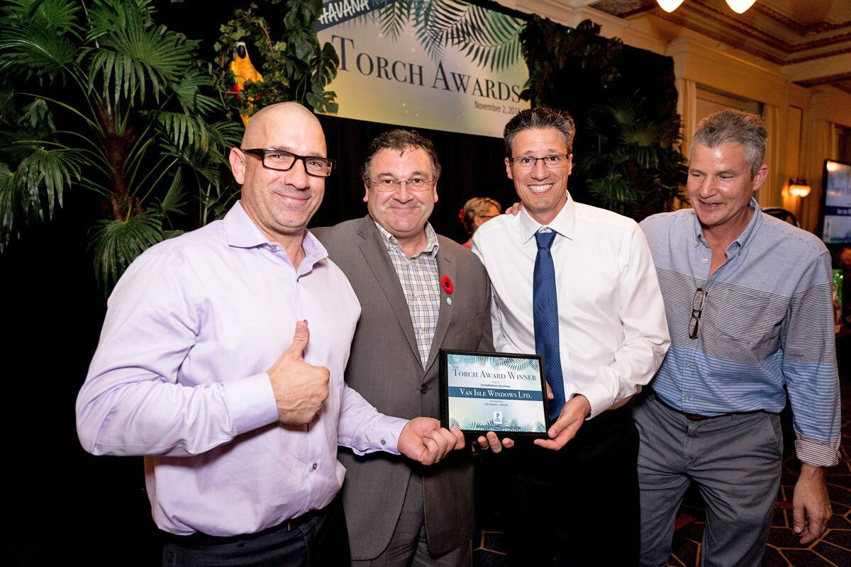 Representatives from Van Isle Windows celebrate a previous Torch Awards win at a gala hosted by the Better Business Bureau serving Vancouver Island. The 2021 finalists were recently announced. (Facebook/Better Business Bureau serving Vancouver Island)