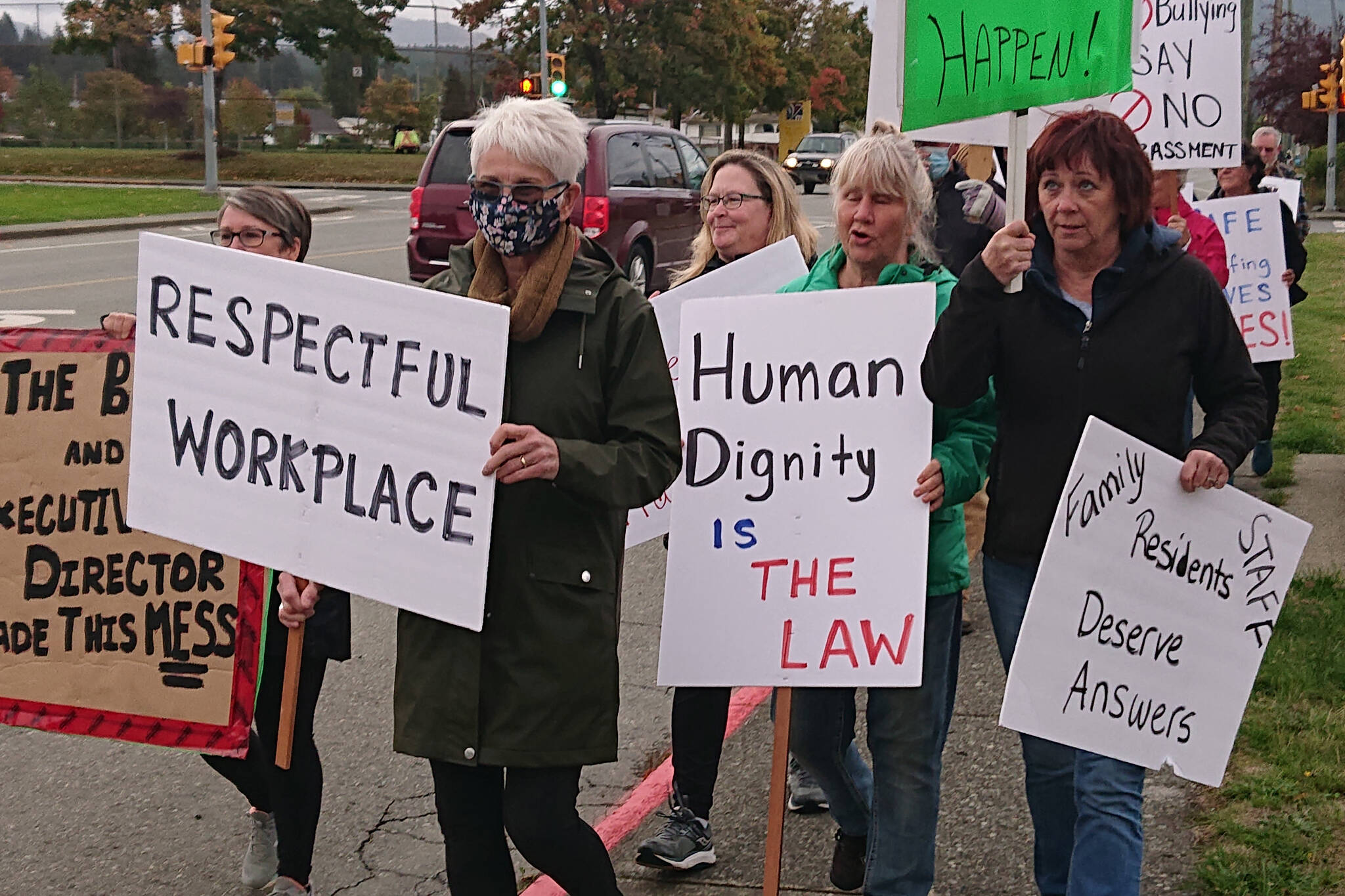 A small group of former workers, workers and family members of residents walk with placards protesting conditions at Fir Park Village on Wallace Street and Echo Village on 10th Avenue, Tuesday, Sept. 28, 2021 in Port Alberni. (MIKE YOUDS/ Special to the AV News)