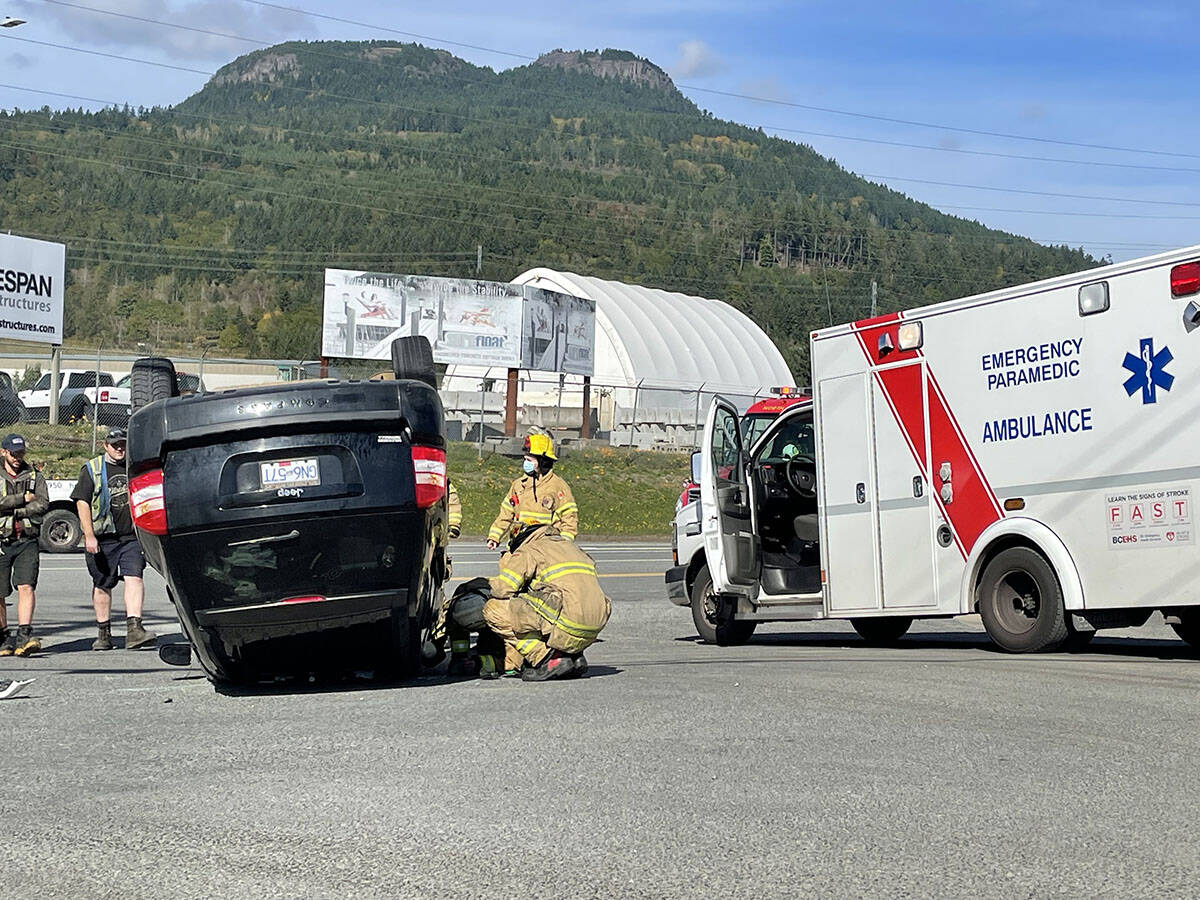 First responders assist at a rollover crash at Drinkwater Road and Highway 18 outside of Duncan on Monday, Oct. 4, 2021.