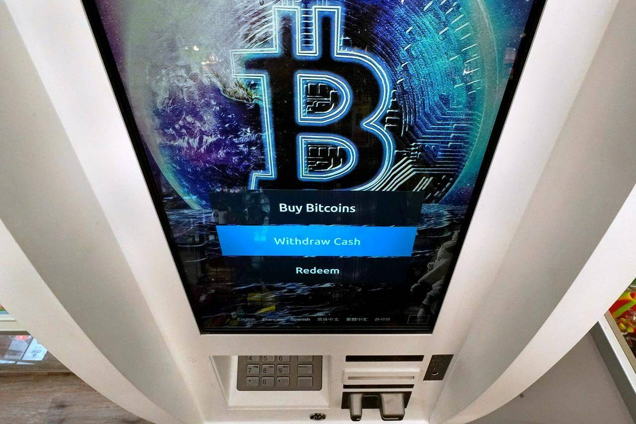 FILE - In this Feb. 9, 2021, file photo, the Bitcoin logo appears on the display screen of a cryptocurrency ATM at the Smoker's Choice store in Salem, N.H. China’s central bank on Friday, Sept. 24, 2021, declared all transactions involving Bitcoin and other virtual currencies illegal, stepping up a campaign to block use of unofficial digital money. (AP Photo/Charles Krupa, File)