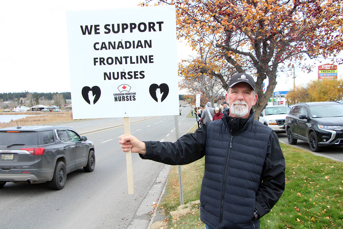 Around 30 members of the public demonstrated by the side of Highway 97 Tuesday, including Mart Blazina, to stand in solidarity with healthcare workers saying no to mandatory vaccines. (Patrick Davies photo - 100 Mile Free Press)