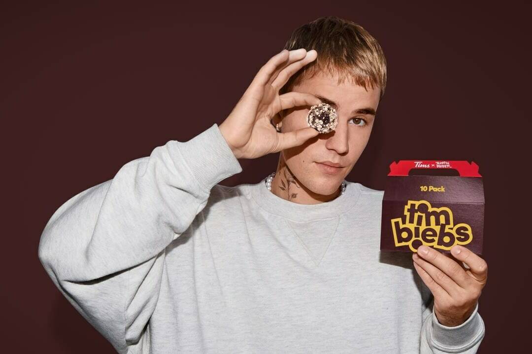 Justin Bieber holds a pack of Tim Hortons' new Timbit flavours, called Timbiebs in this undated handout photo. Tim Hortons has teamed up with pop superstar Justin Bieber to launch three new Timbit flavours called Timbiebs along with co-branded merchandise. Tim Hortons will roll out the limited-edition Timbiebs Timbits in chocolate white fudge, sour cream chocolate chip, and birthday cake waffle on Nov. 29, exclusively in Canada and the United States.THE CANADIAN PRESS/HO, Tim Hortons *MANDATORY CREDIT*
