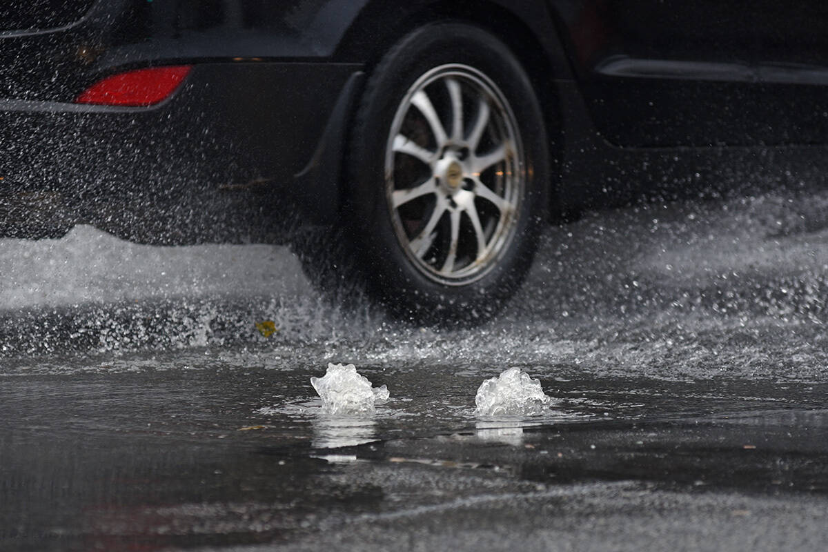Water bubbles up through a manhole cover on Yates Street at Cook Street due to heavy rains. Monday was the wettest Nov. 15 in history across much of Greater Victoria, according to Environment Canada. (Don Denton/Black Press Media)