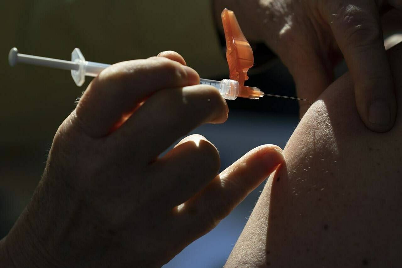 A dose of the Pfizer-BioNTech vaccine is given to a recipient at a vaccination site in Vancouver Thursday, March 11, 2021. The federal government is set to make two major announcement on the pandemic front Friday, starting with the approval of Canada’s first COVID-19 vaccine for children, then later detailed plans to ease some of the pandemic-related measures at the border. THE CANADIAN PRESS/Jonathan Hayward