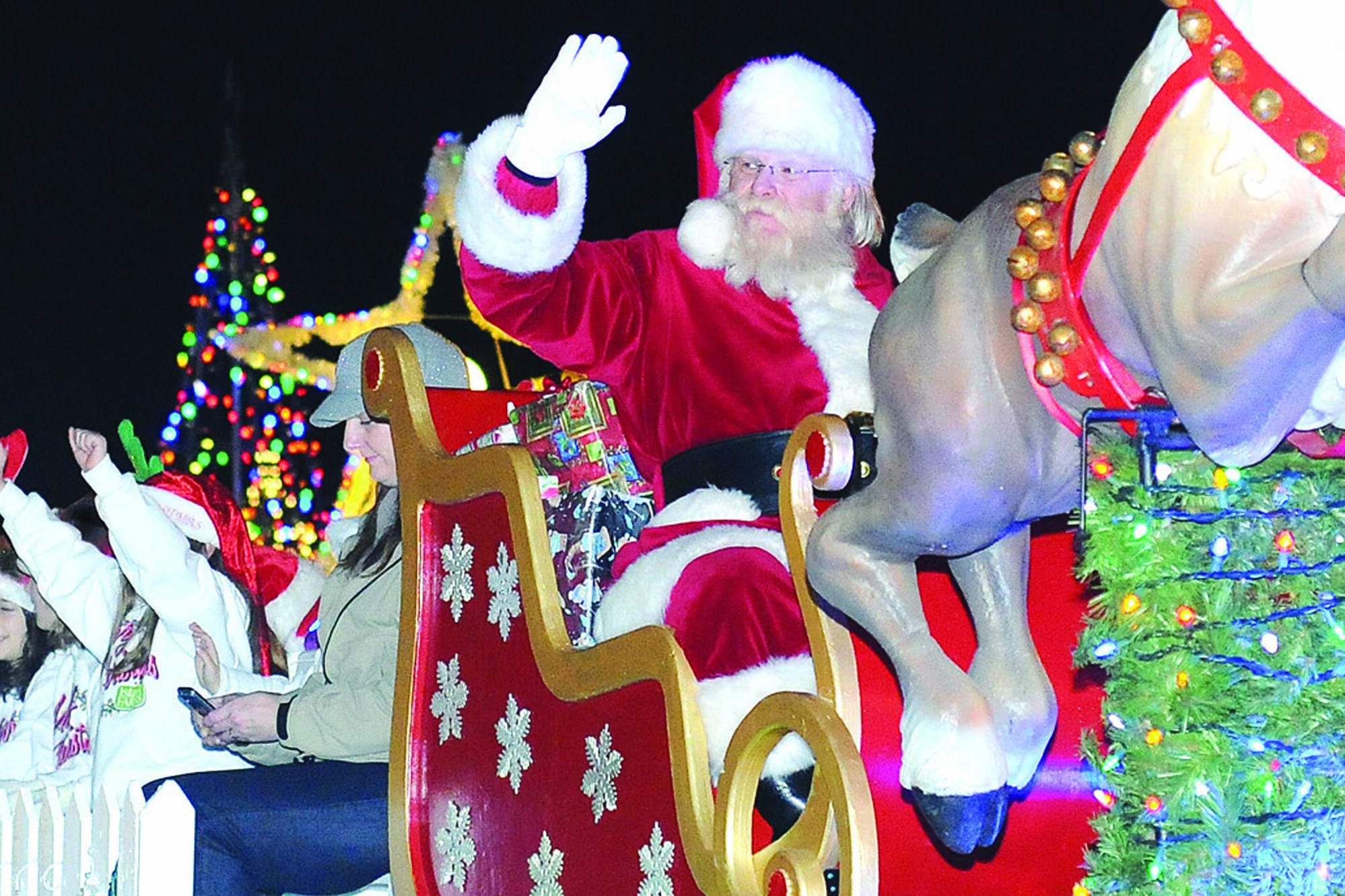 Santa Claus waves to an excited crowd lining Government Street during a previous Santa’s Light Parade. This year’s event takes off from the legislature at 5:30 p.m. (Black Press Media file photo)