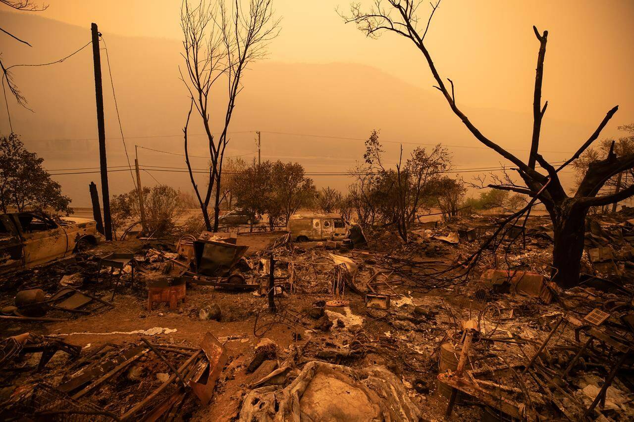 Thick smoke fills the air and nearly blocks out the sun as a property destroyed by the White Rock Lake wildfire is seen in Monte Lake, east of Kamloops, B.C., on Saturday, Aug. 14, 2021. New research suggests the risk of extreme wildfire events is increasing across the globe, with some of the largest increases in Western Canada.THE CANADIAN PRESS/Darryl Dyck